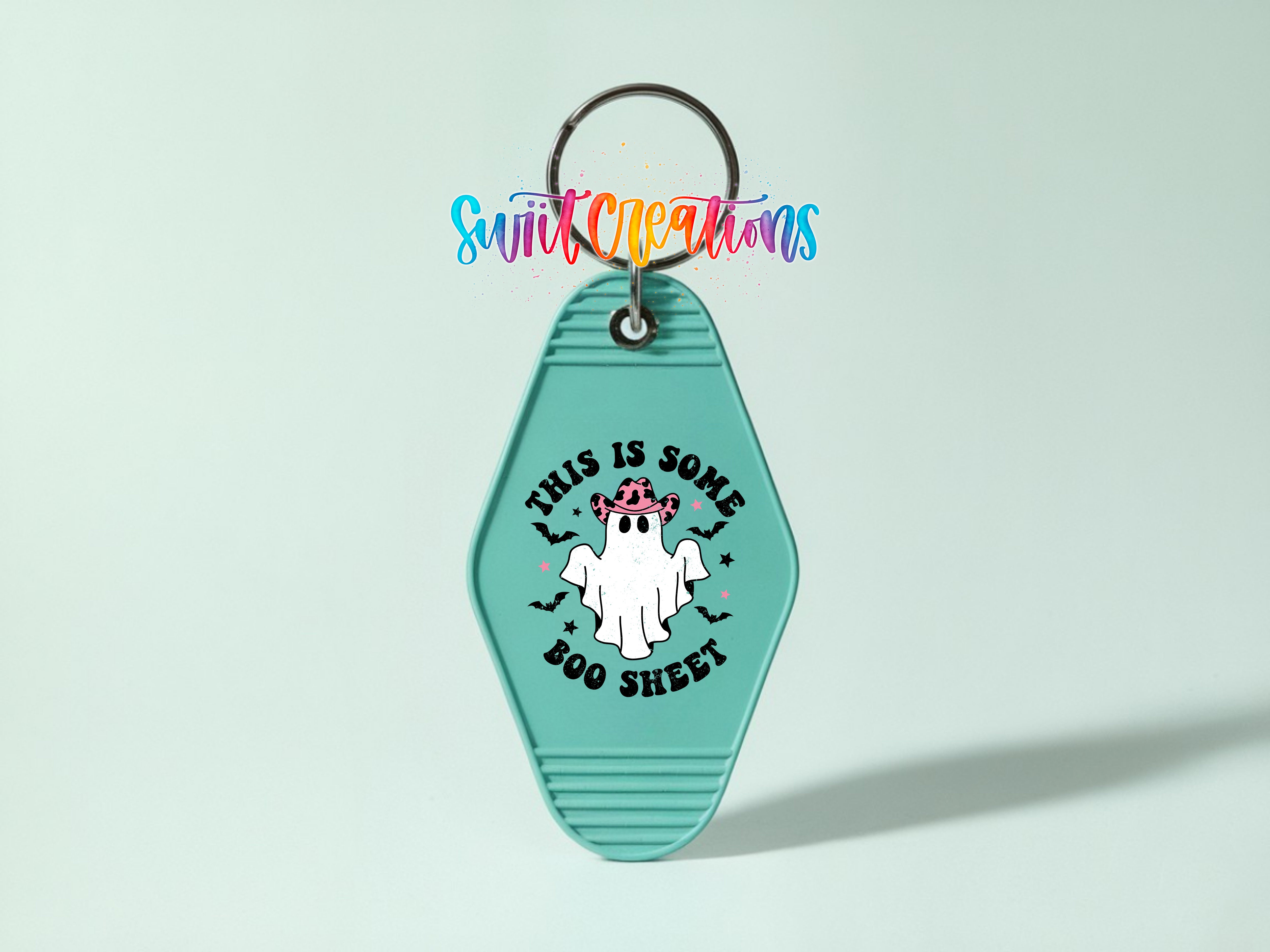 A keychain with a green hexagonal shape and a ghost design, along with the text "This is some Boo Sheet" printed on it.
