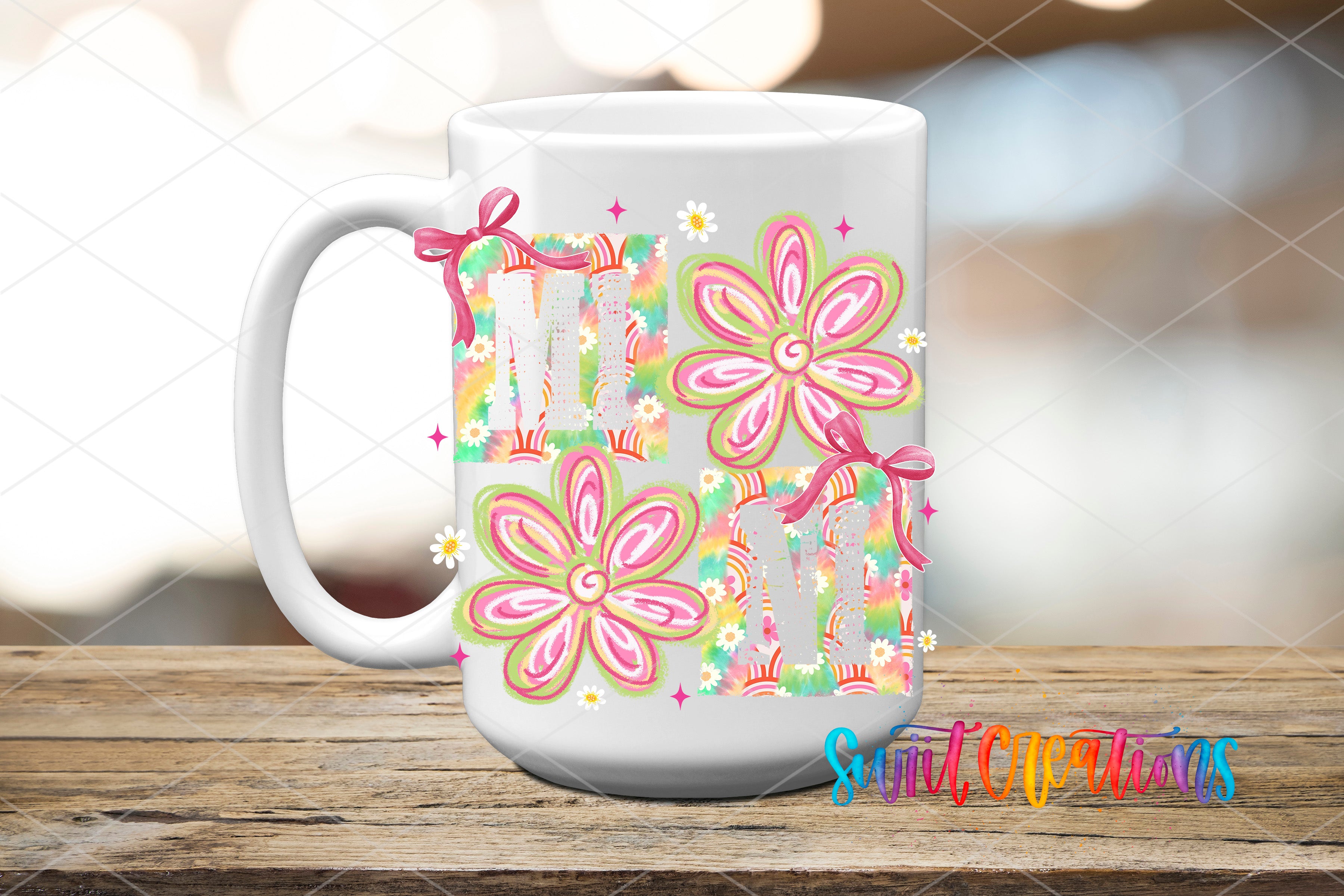 A white ceramic mug with colorful floral designs and the word "MOM" printed on it, placed on a wooden surface.