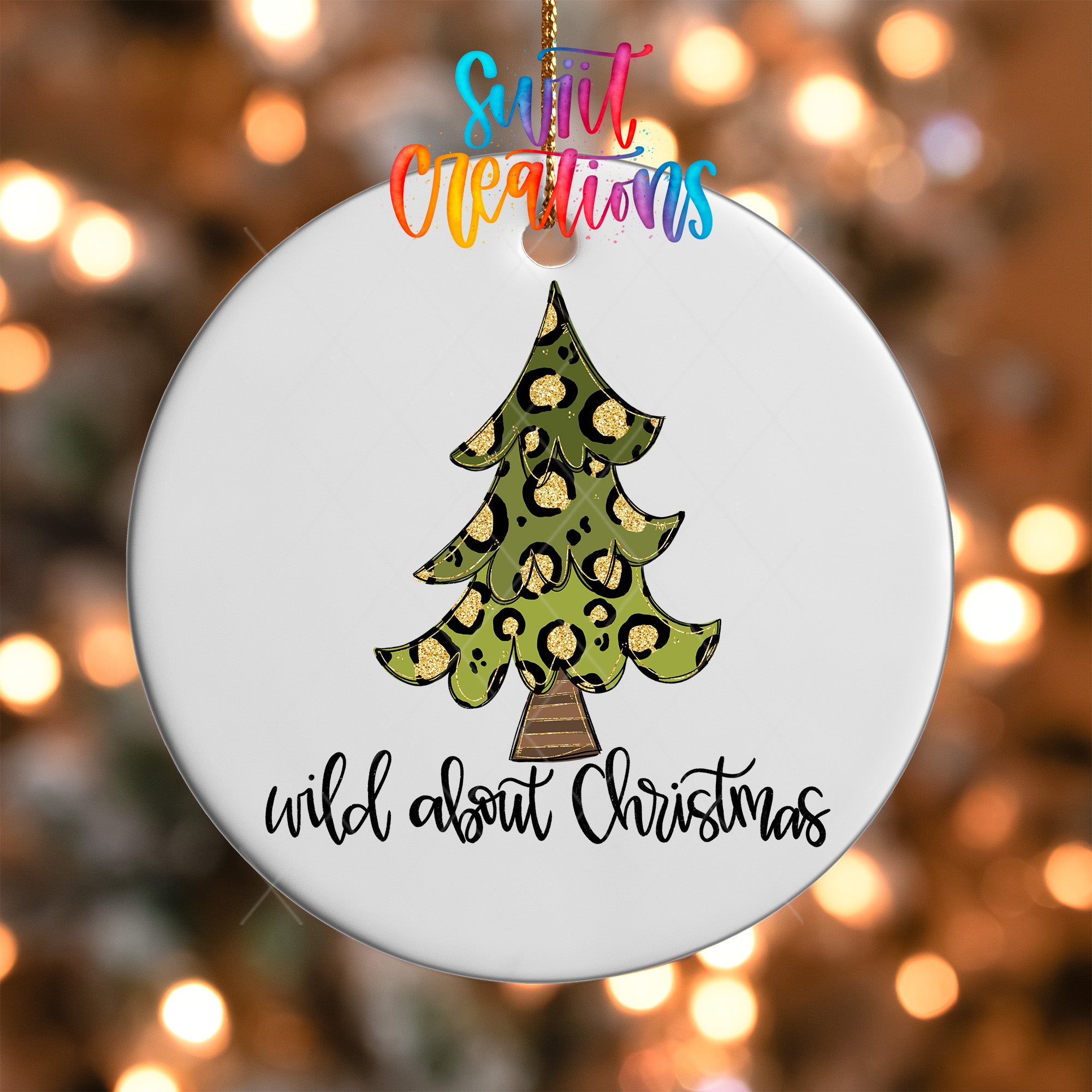 A white Christmas ornament with a leopard print design and the text "wild about Christmas" printed on it.