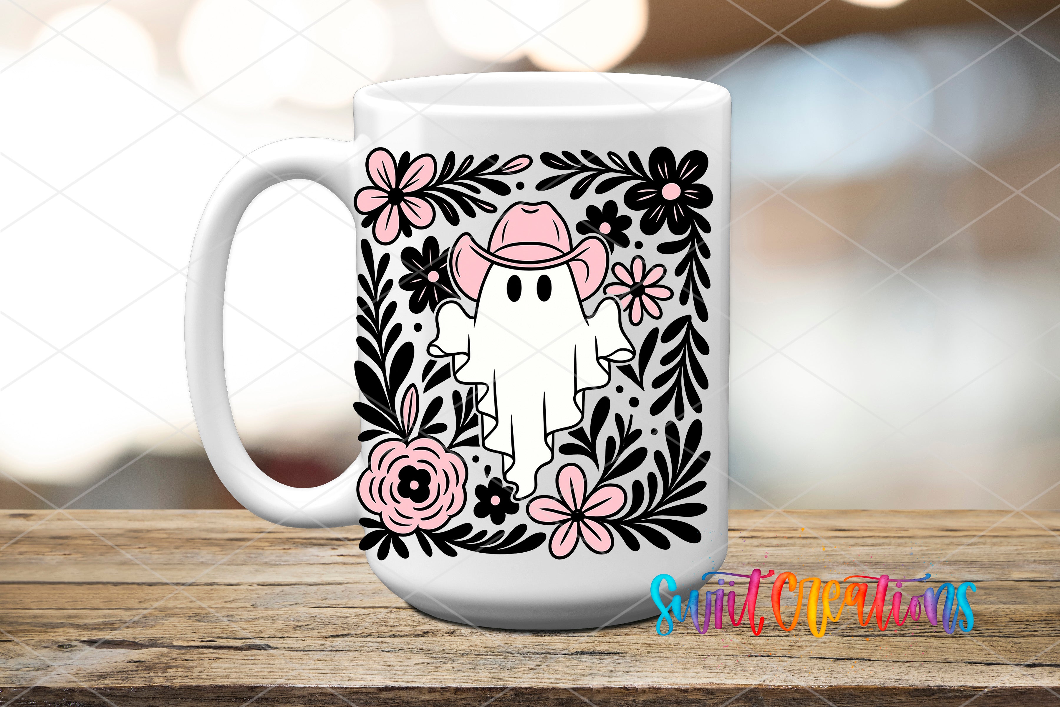 A white mug with a black and pink floral design featuring a ghost wearing a cowboy hat, surrounded by flowers and leaves.