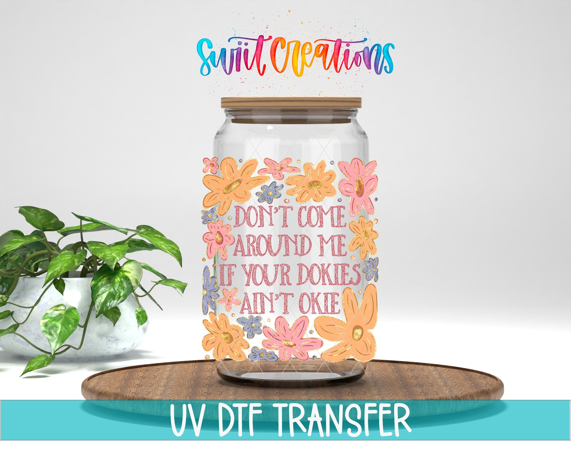 a glass jar with a floral design and text printed on it, placed on a wooden surface.