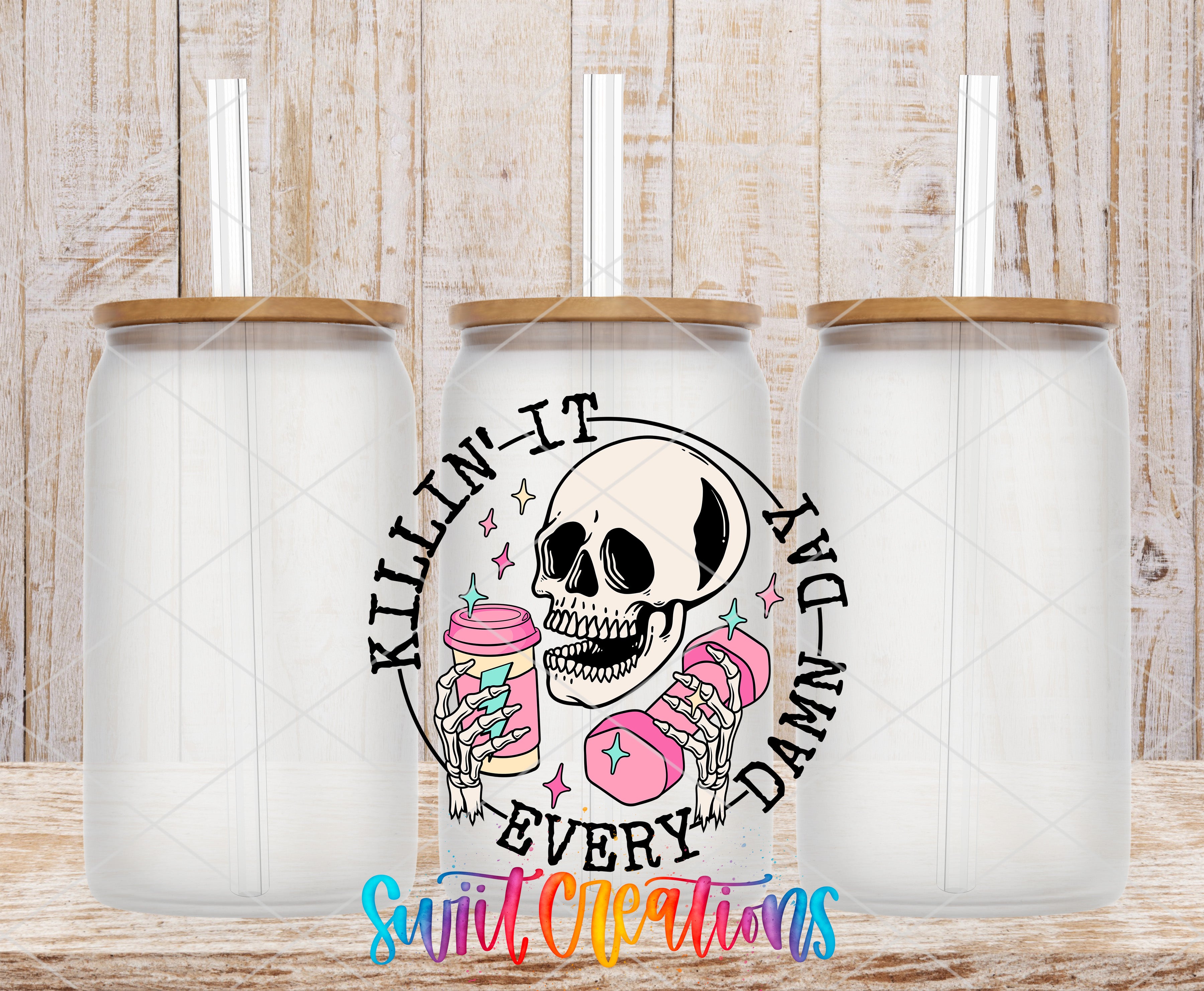 three clear glass jars with lids, each containing a pink drink. The jars are arranged in a row, and there is a skull design on the center jar. The text "KILLIN' IT EVERY DAY DAMN' IT" is displayed around the skull design, which appears to be a reference to the popular song "U Can't Touch This" by the band U Can't Touch This.