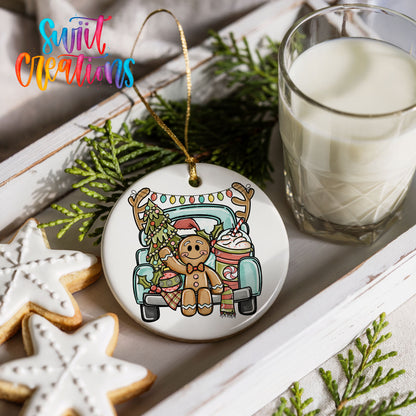 a Christmas ornament with a gingerbread man and a truck, along with a glass of milk and some cookies.