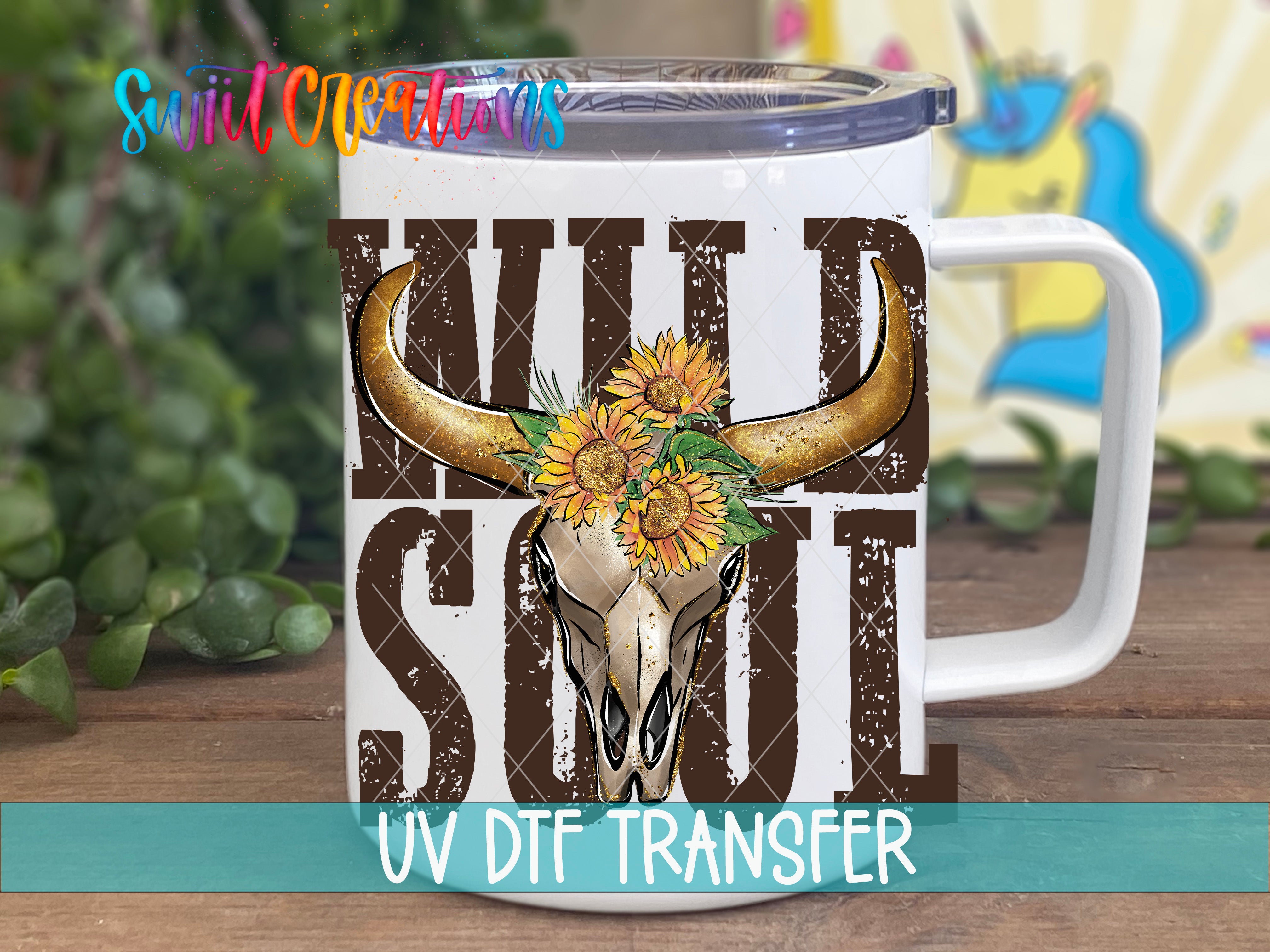 A white mug with a graphic design featuring a bull's head and sunflowers, along with the text "WILD SOUL" printed on it.