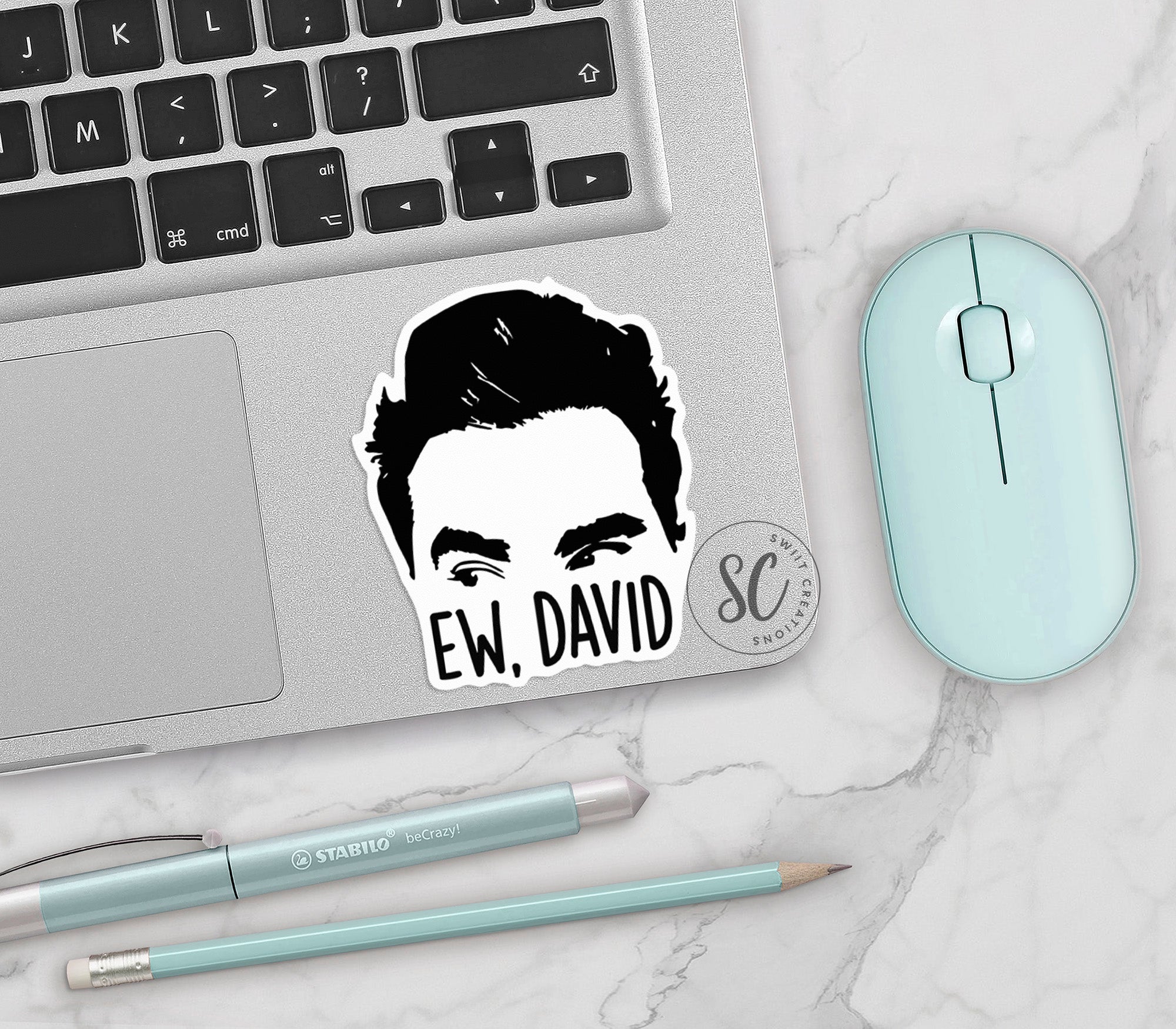 a laptop with a sticker of a man's face on it