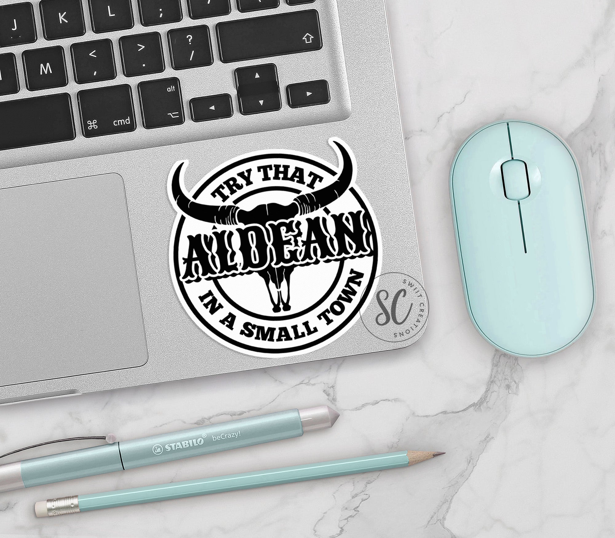 a laptop with a sticker of a bull's head on it