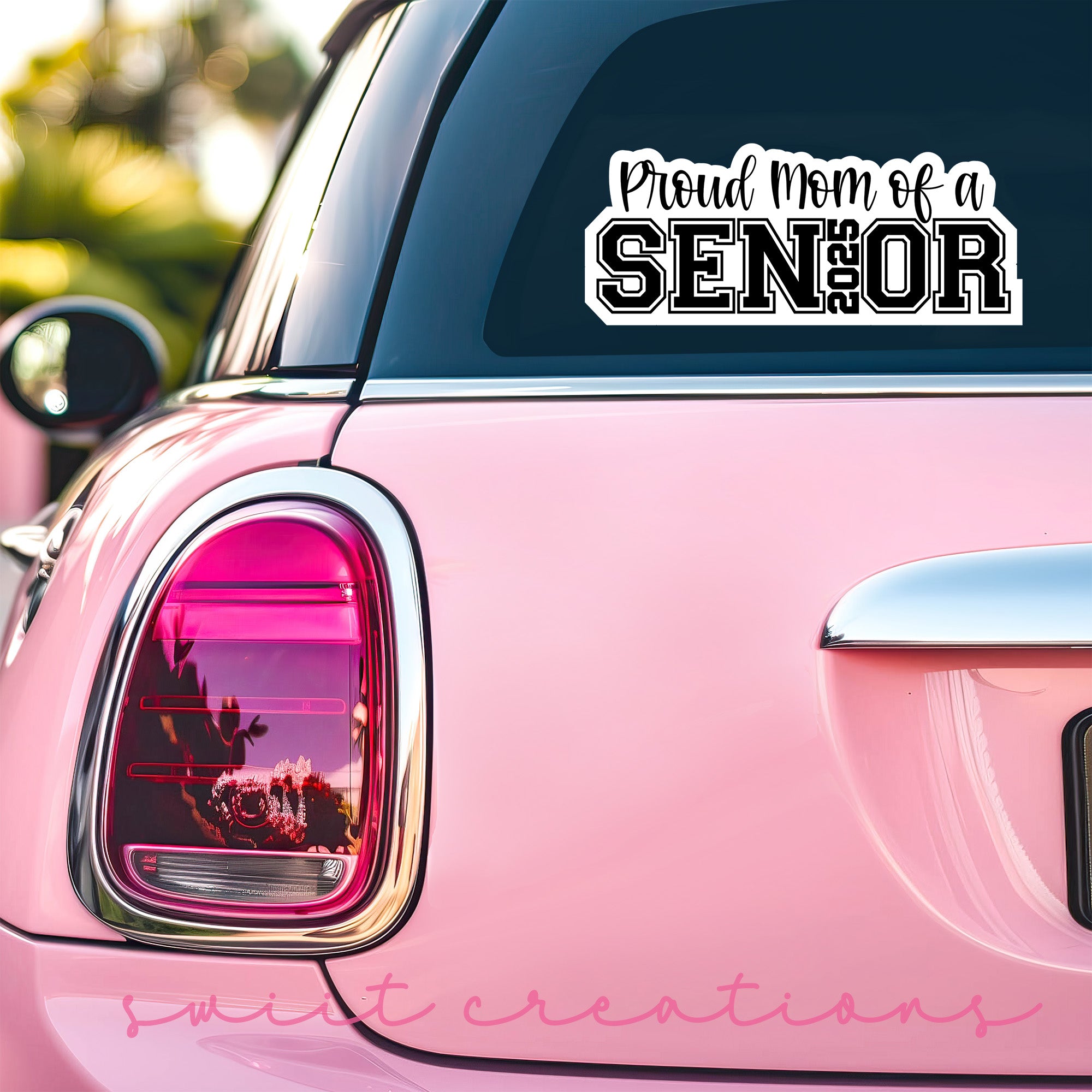 a pink car with a sticker that says proud mom of a senior