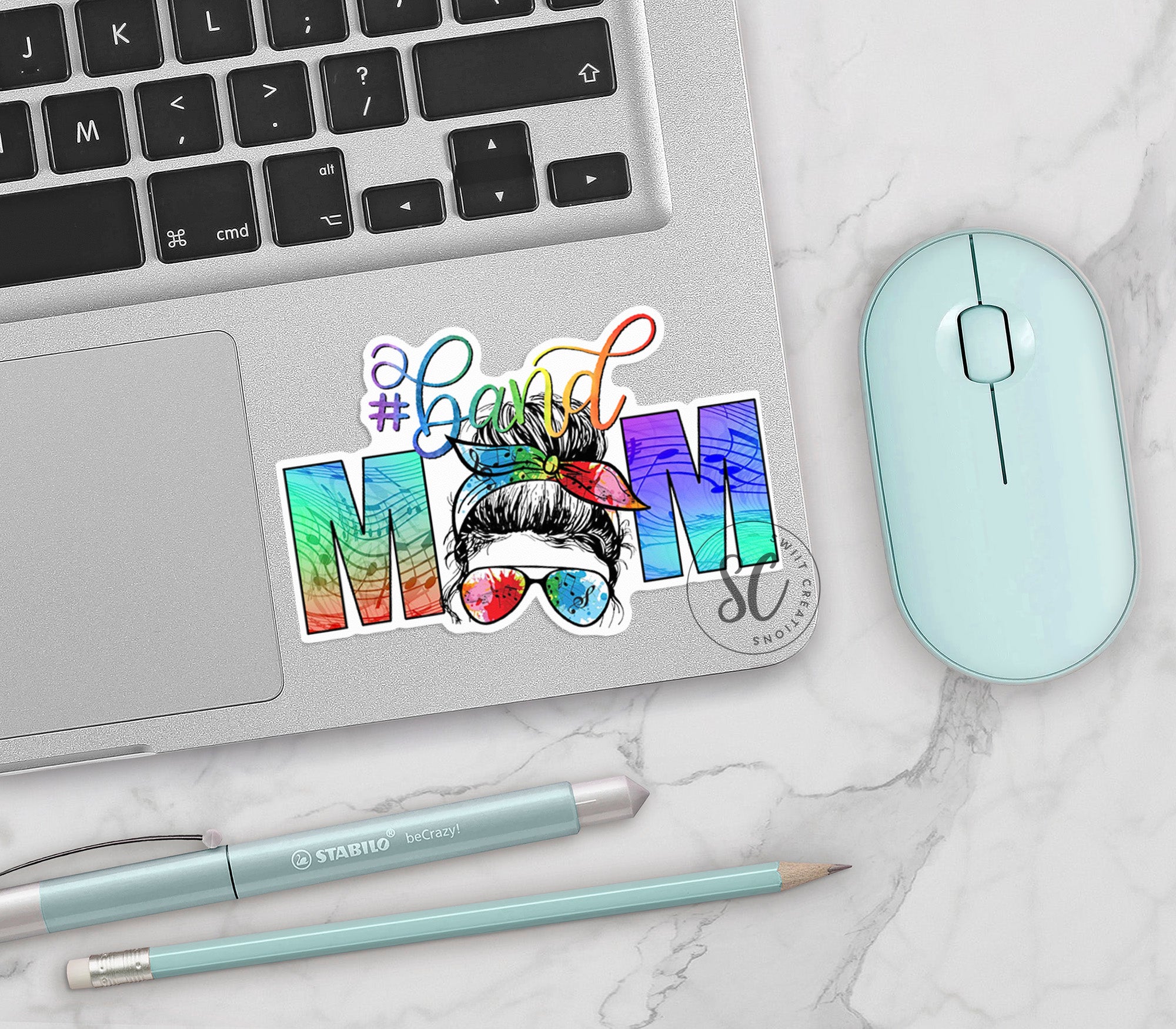 a laptop computer sitting next to a mouse