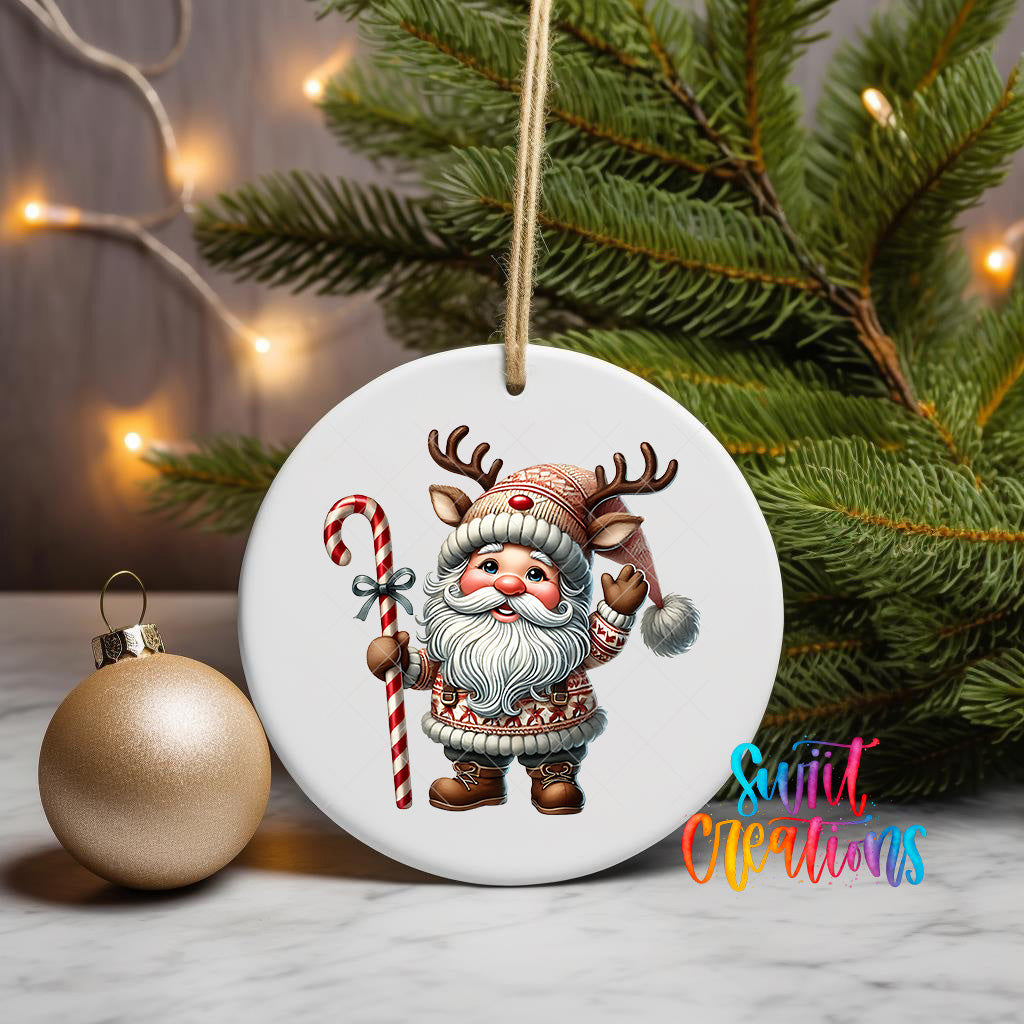 A white ceramic ornament featuring a cartoon Santa Claus holding a candy cane and wearing a red and white striped hat, with a Christmas tree in the background.