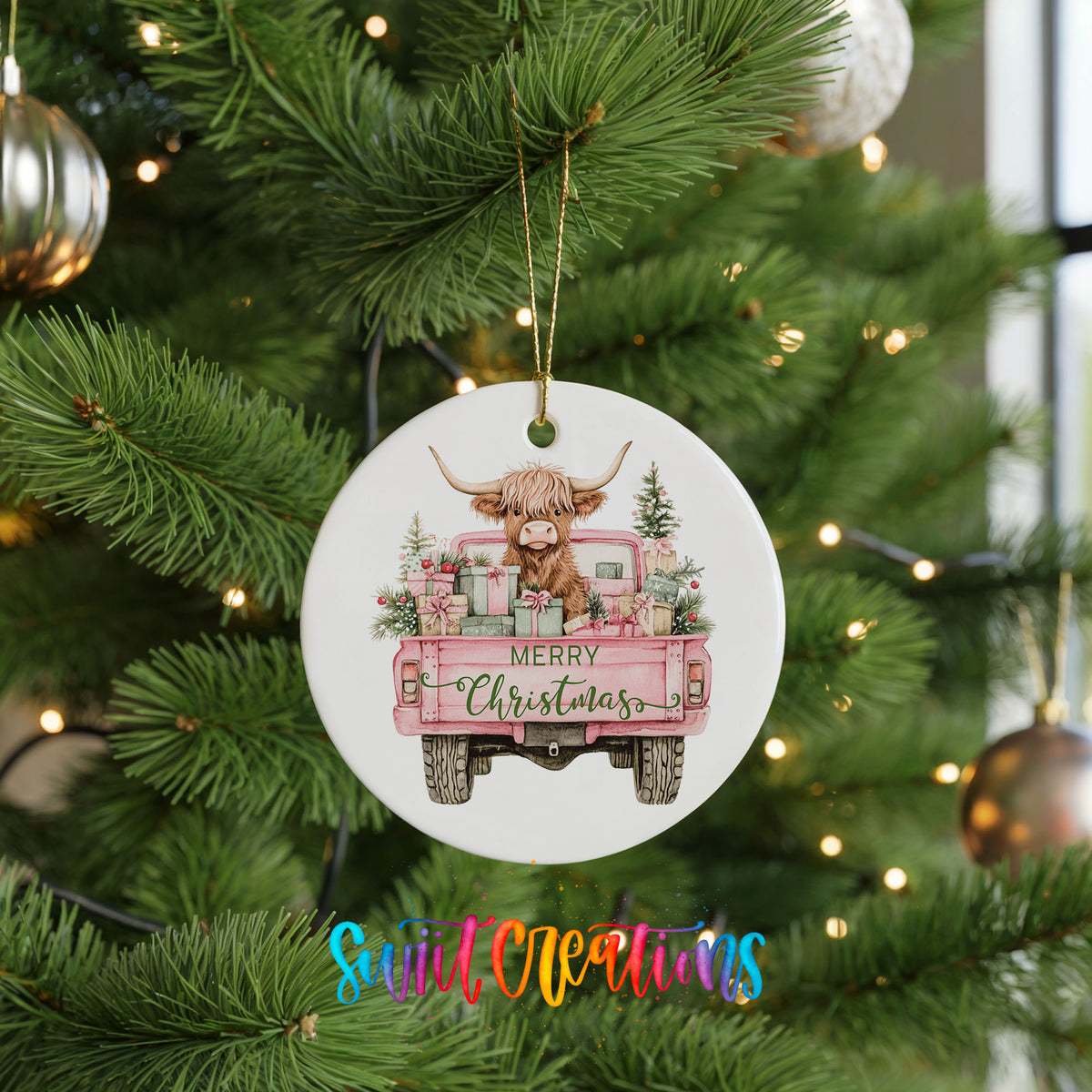 A Christmas tree ornament featuring a pink truck with a cow and presents, with the text "MERRY CHRISTMAS" displayed on the back of the truck.