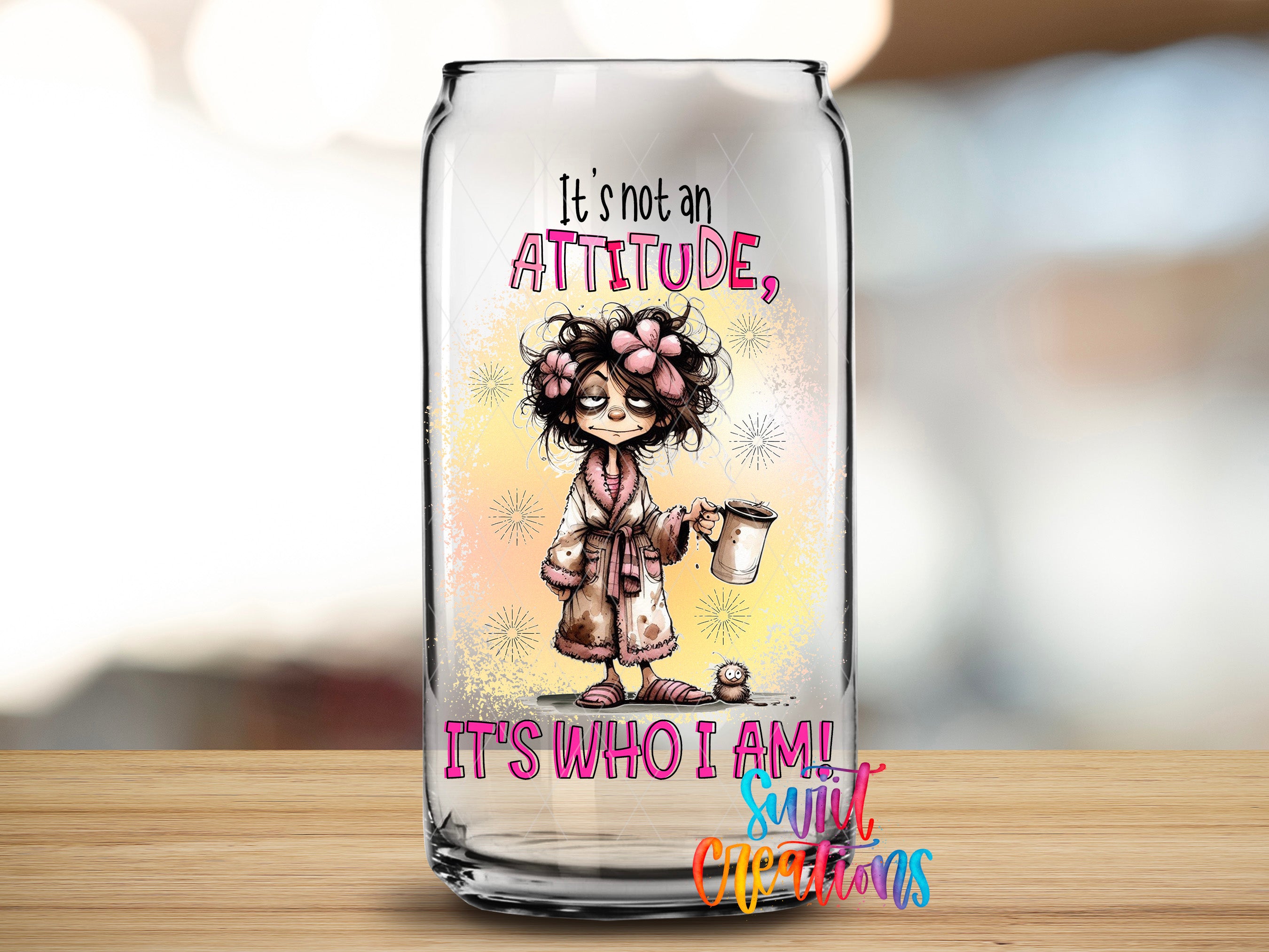 A glass can with a cartoon illustration of a person wearing a bathrobe and holding a cup, along with the text "It's not an attitude, it's who I am!"