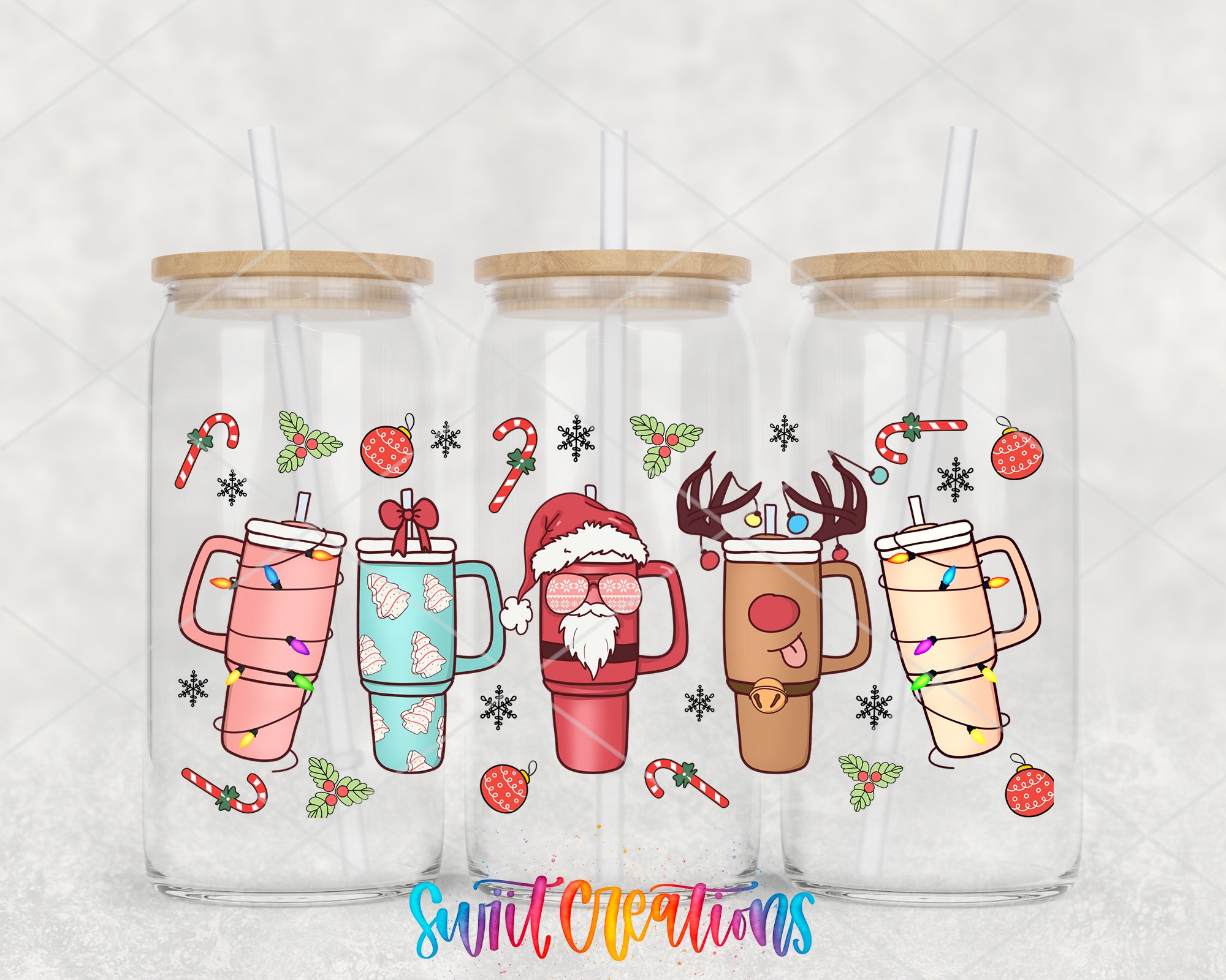 A collection of three glass tumblers with colorful designs and festive decorations, including Santa Claus, reindeer, snowflakes, and candy canes.