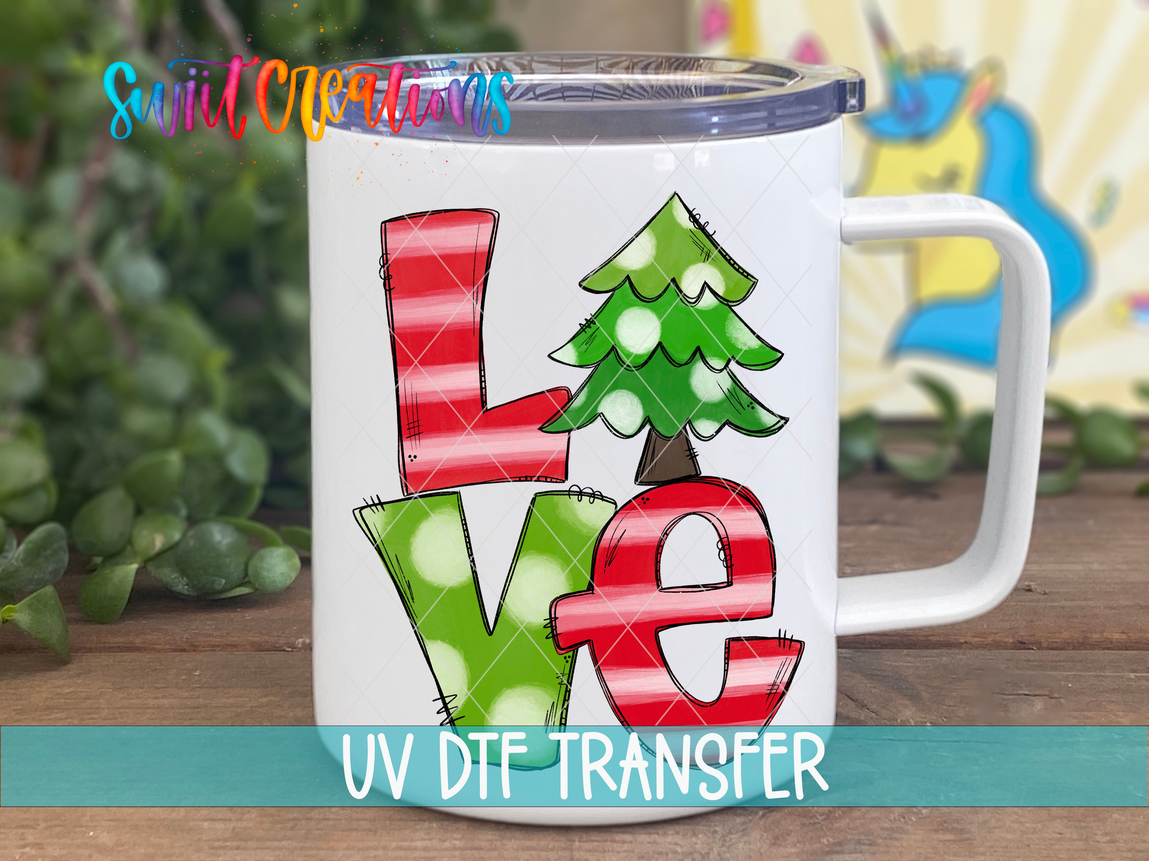 A white mug with a colorful graphic design featuring the word "LOVE" in red and green colors, along with a Christmas tree and polka dots.