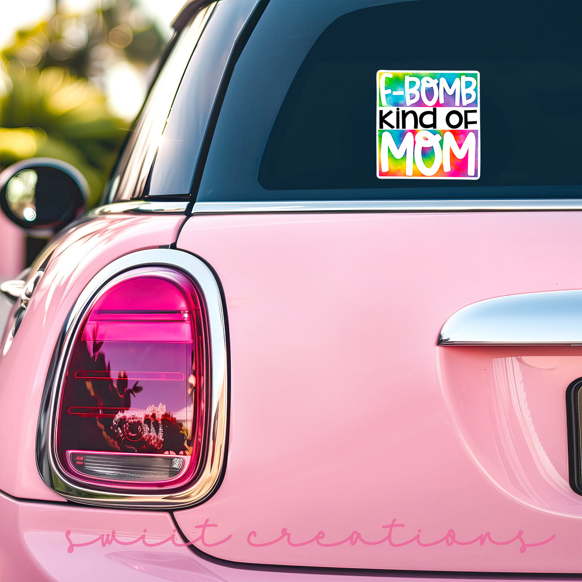 a pink car with a sticker that says bomb kind of mom