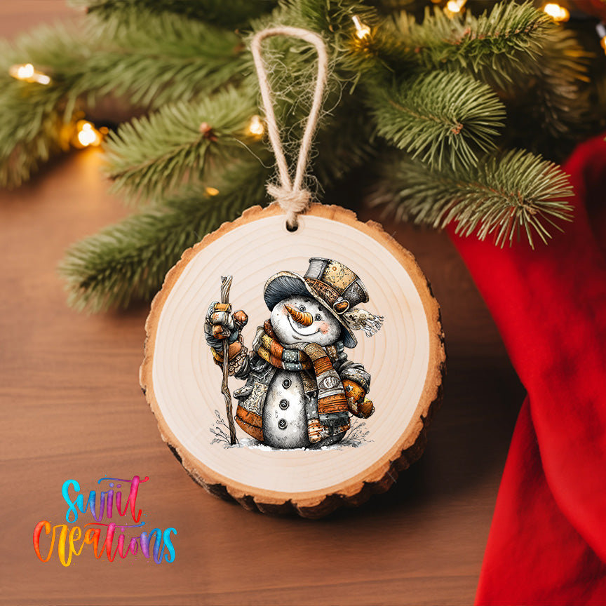 A wooden ornament featuring a snowman is hanging on a Christmas tree, surrounded by pine branches and twinkling lights.