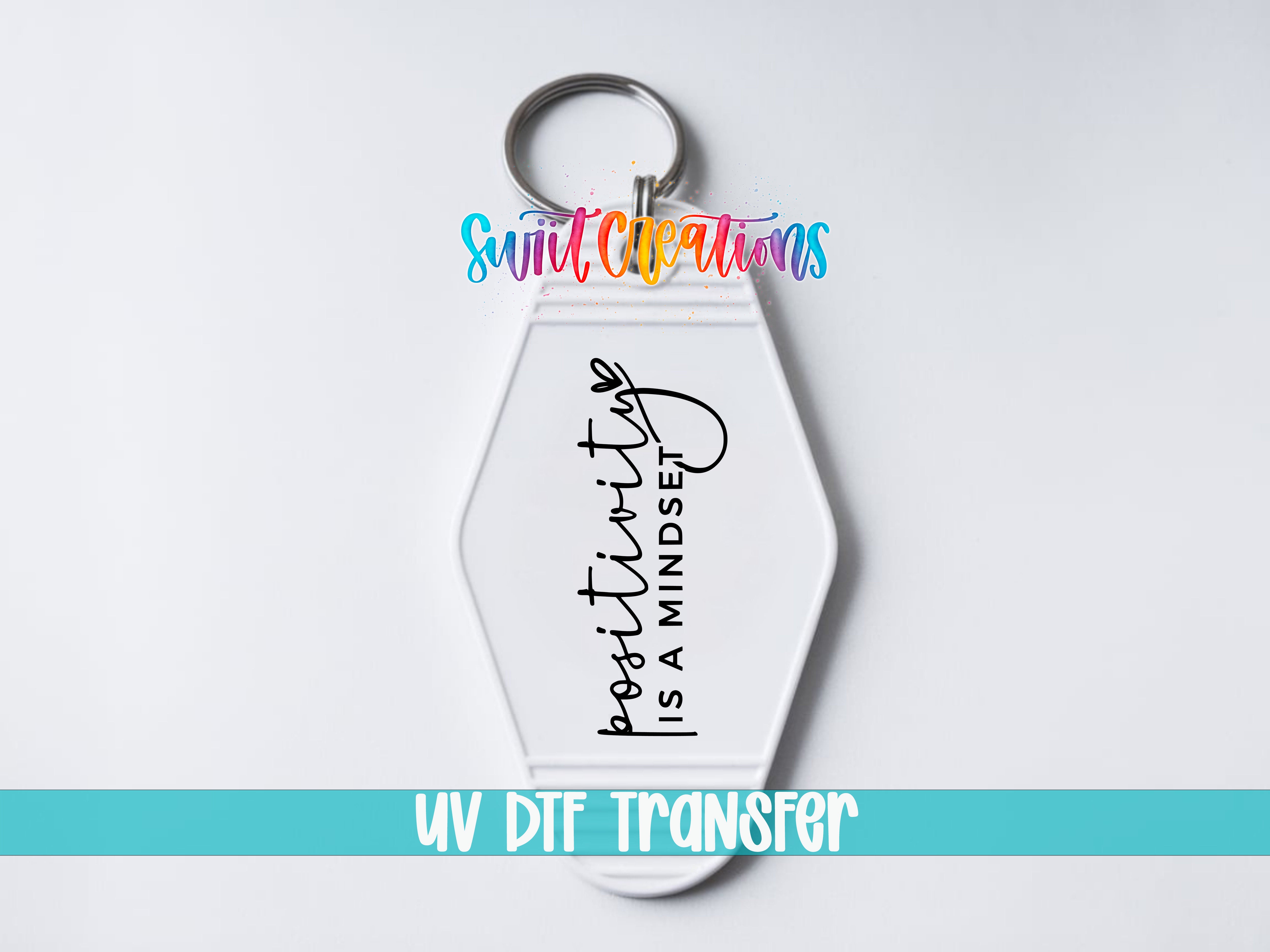 A keychain with a message printed on it, which says "positivity is a mindset".