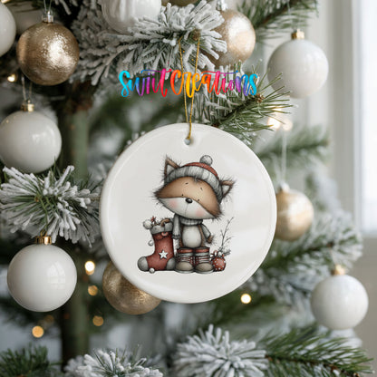 whimsical Christmas cat ceramic Christmas ornament hanging on a frosted tree with ornaments