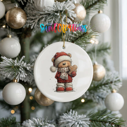 teddy bear in a Santa hat holding a gingerbread cookie ceramic Christmas ornament hanging on a frosted tree with ornaments