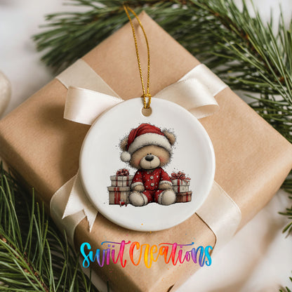 seated teddy bear with Christmas gifts ceramic Christmas ornament displayed on a wrapped Christmas gift