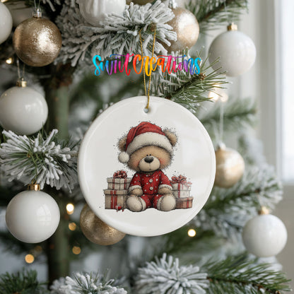 seated teddy bear with Christmas gifts ceramic Christmas ornament hanging on a frosted tree with ornaments