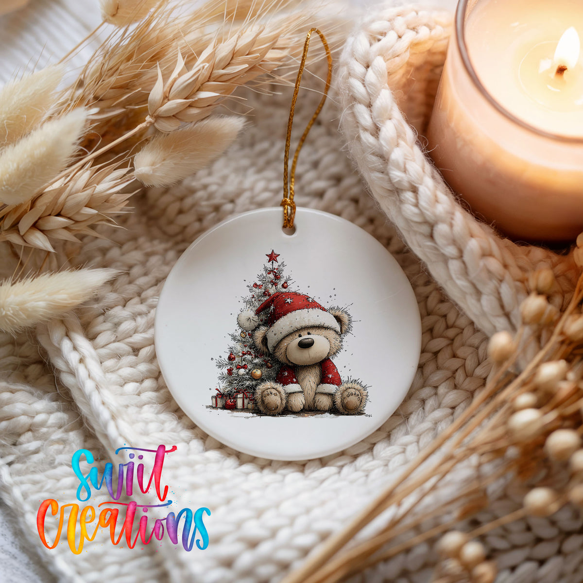 teddy bear sitting beside a decorated Christmas tree ceramic Christmas ornament styled on a cozy knit blanket