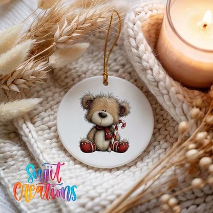 teddy bear with a candy cane and red Christmas ornament ceramic Christmas ornament styled on a cozy knit blanket