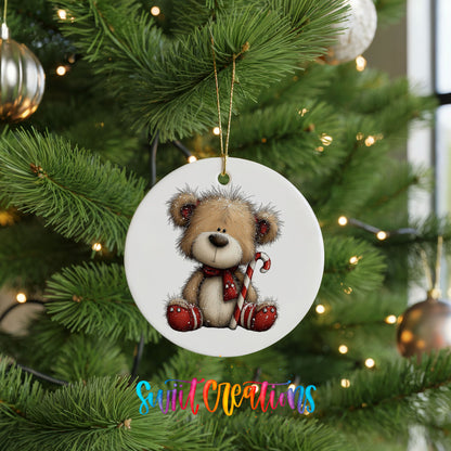 teddy bear with a candy cane and red Christmas ornament ceramic Christmas ornament hanging on a lit Christmas tree