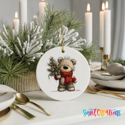 teddy bear in a red scarf holding a Christmas tree ceramic Christmas ornament shown in a holiday table setting