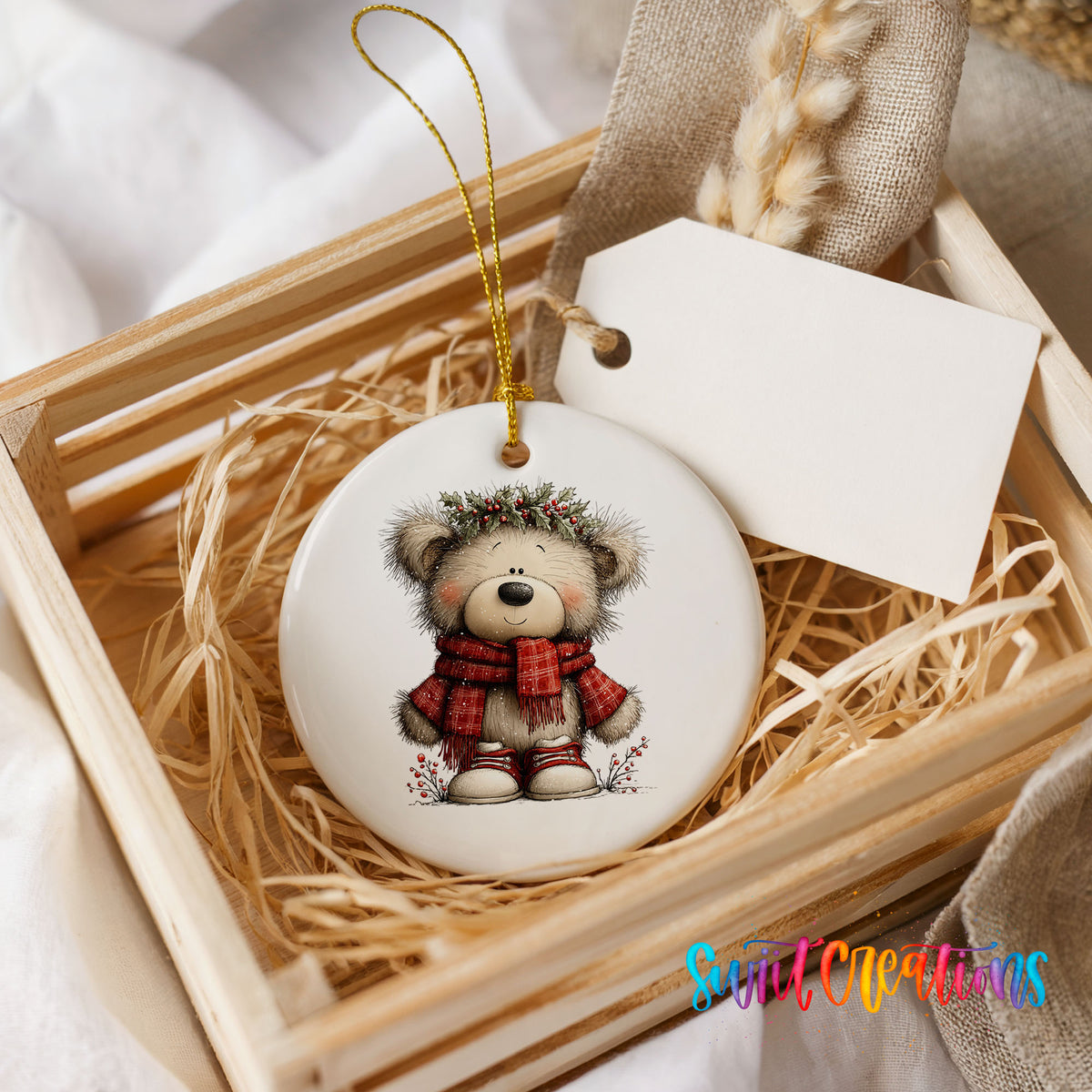 teddy bear in a red plaid scarf with holly ceramic Christmas ornament displayed in a wooden gift crate