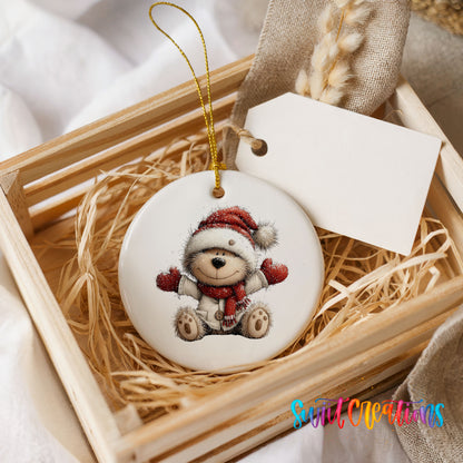 seated teddy bear in a Santa hat and red scarf ceramic Christmas ornament displayed in a wooden gift crate