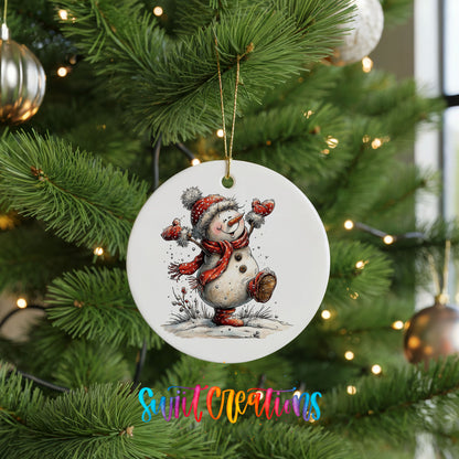 playful snowman in a red scarf ceramic Christmas ornament hanging on a lit Christmas tree