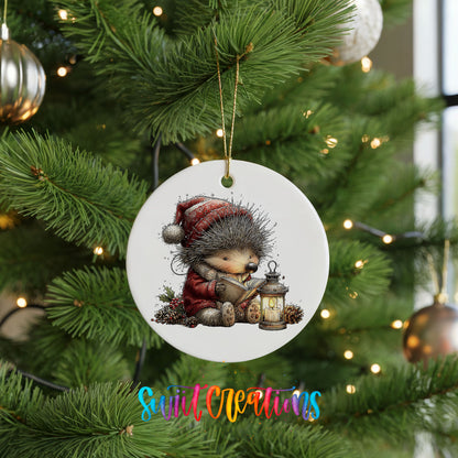 woodland bear in a Santa hat holding a lantern ceramic Christmas ornament hanging on a lit Christmas tree