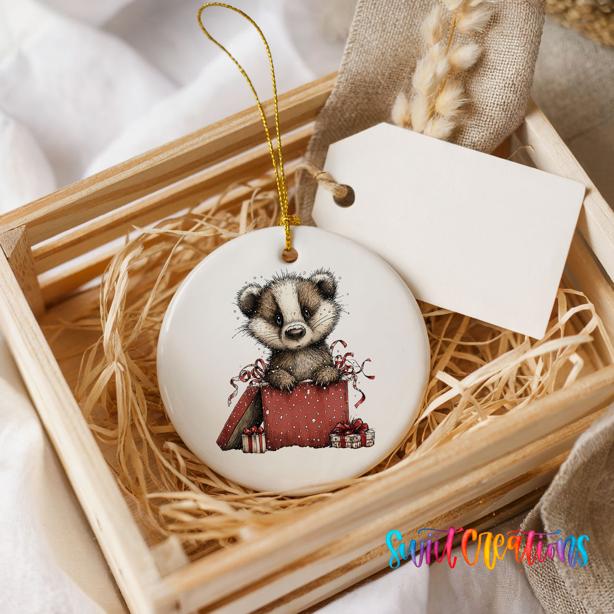woodland badger carrying a red Christmas gift sack ceramic Christmas ornament displayed in a wooden gift crate