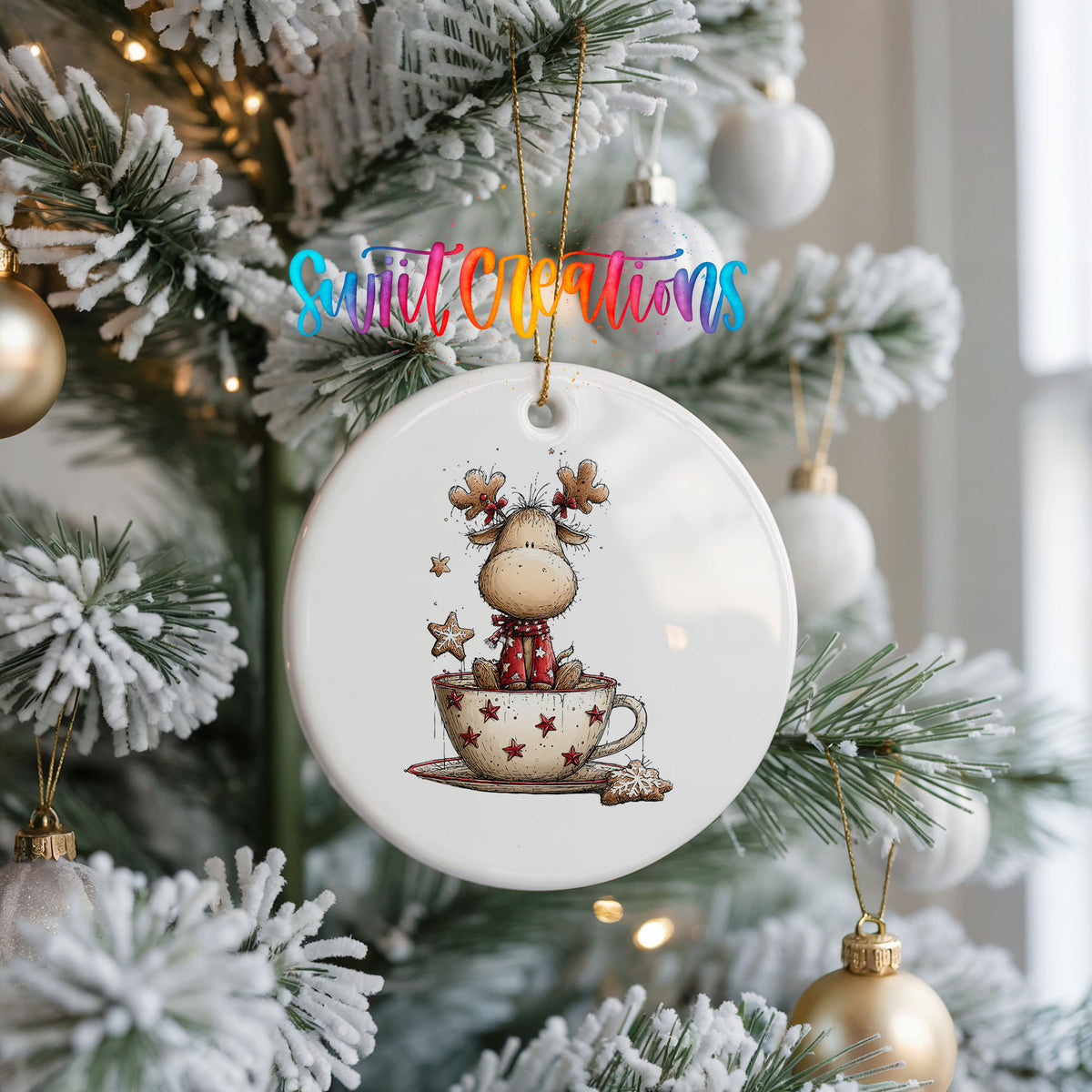 woodland reindeer sitting in a holiday teacup ceramic Christmas ornament hanging on a frosted Christmas tree