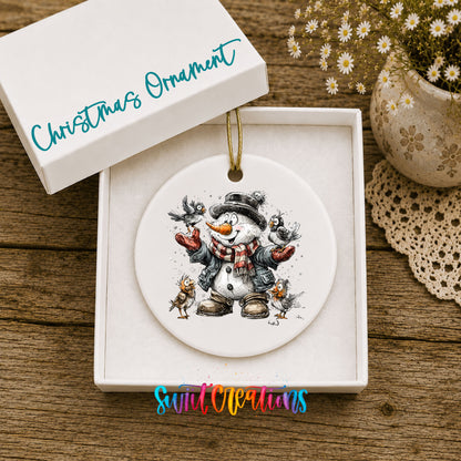 cheerful snowman in a black hat surrounded by birds ceramic Christmas ornament presented in a gift box