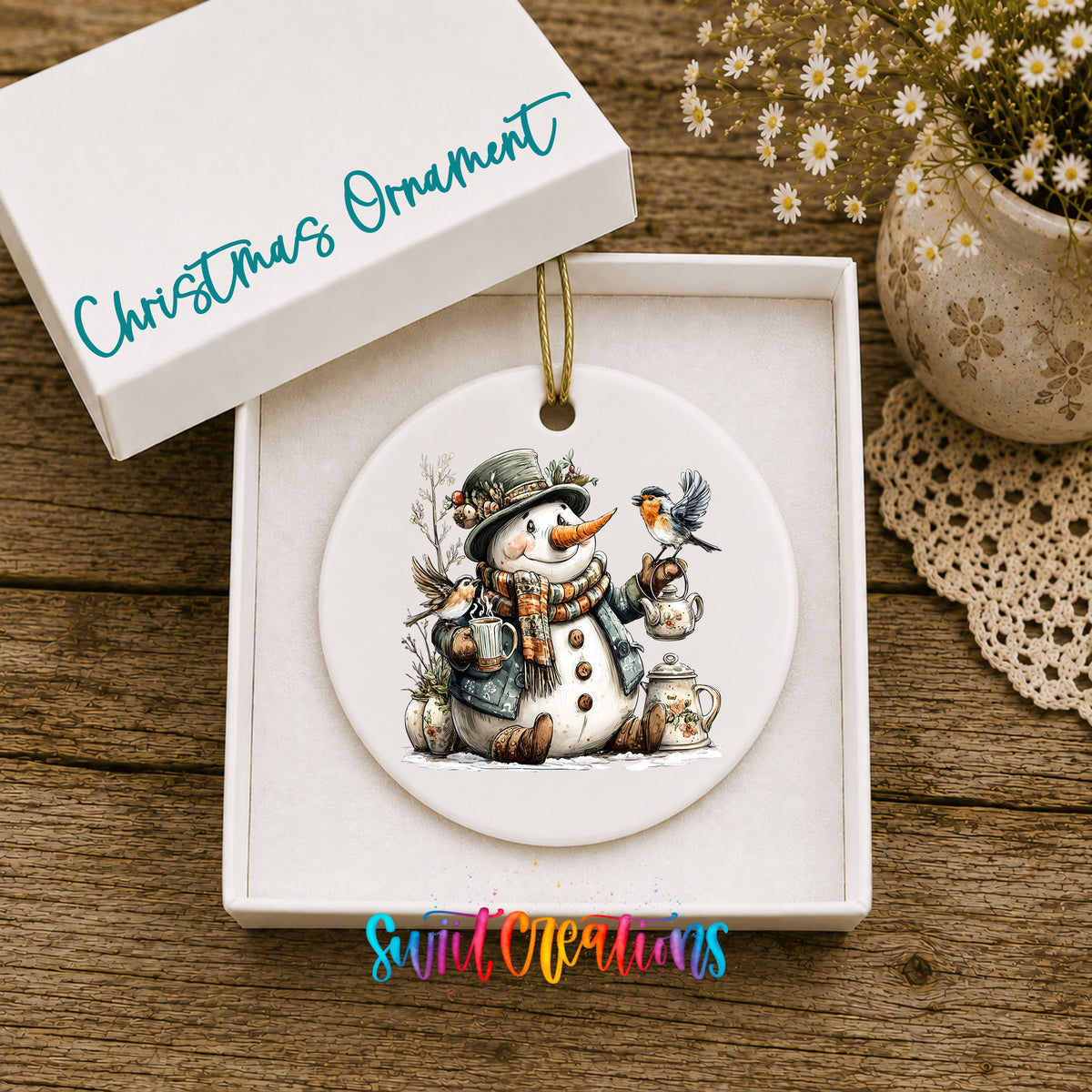 snowman with a lantern and winter birds ceramic Christmas ornament presented in a gift box