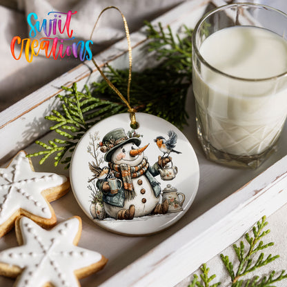 snowman with a lantern and winter birds ceramic Christmas ornament styled with holiday cookies and a candle