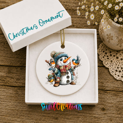 snowman in a blue hat with colorful winter birds ceramic Christmas ornament presented in a gift box