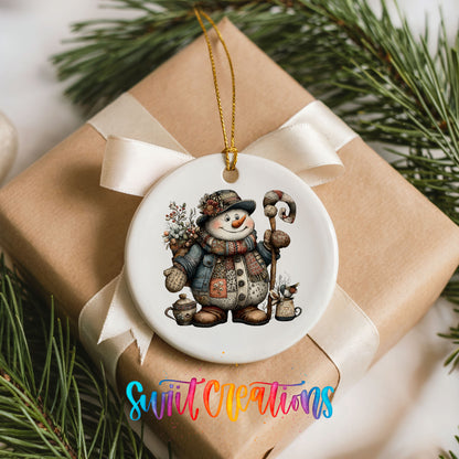 snowman in a brown winter hat holding a candy cane ceramic Christmas ornament displayed on a wrapped Christmas gift
