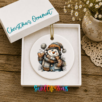 snowman in a striped knit hat and winter mittens ceramic Christmas ornament presented in a gift box