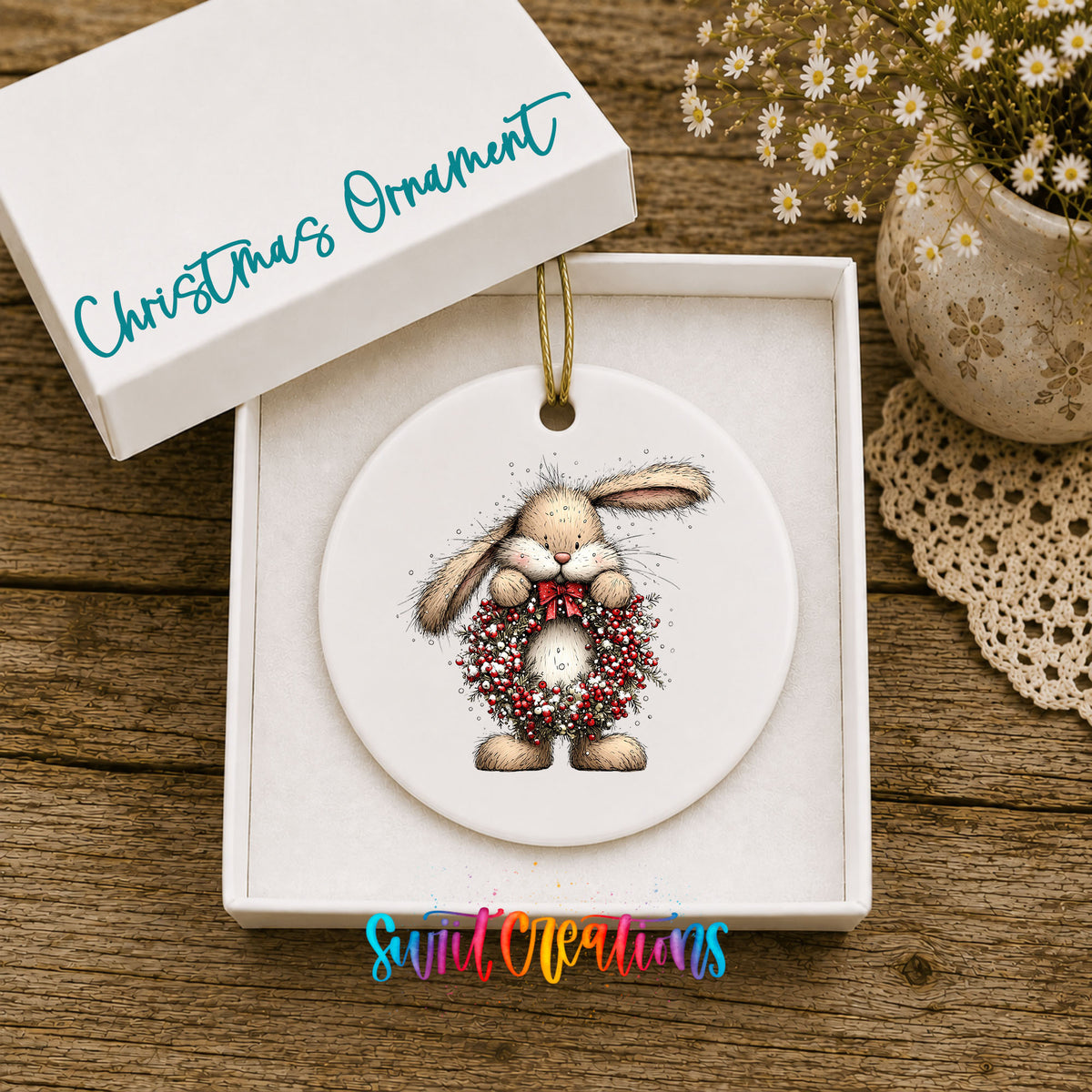 woodland rabbit holding a red berry wreath ceramic Christmas ornament presented in a gift box