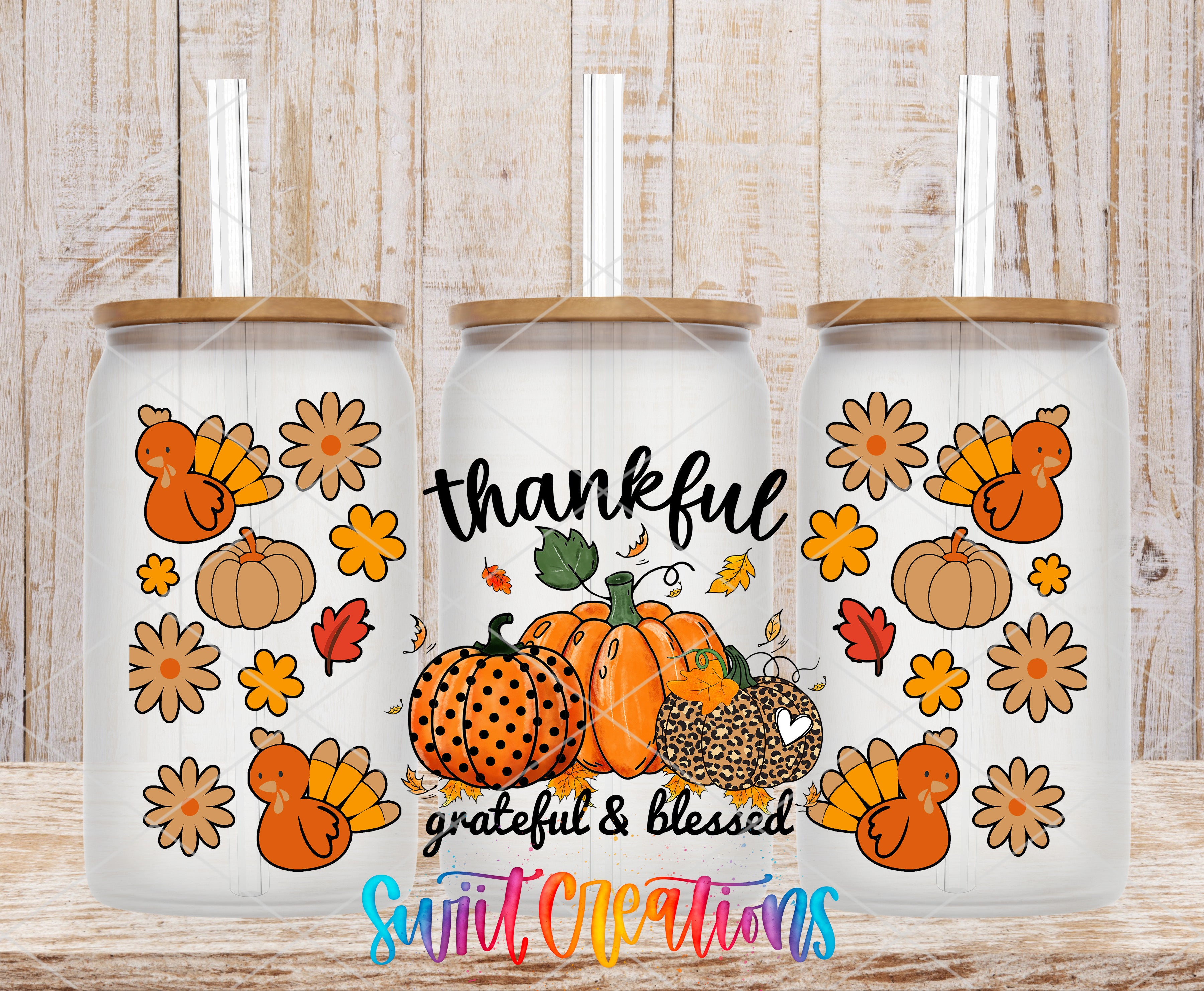 three glass tumblers with a Thanksgiving theme, including pumpkins, leopards, and turkeys. The tumblers have a lid and straw, and the text "Thankful,grateful & Blessed" is displayed on them.