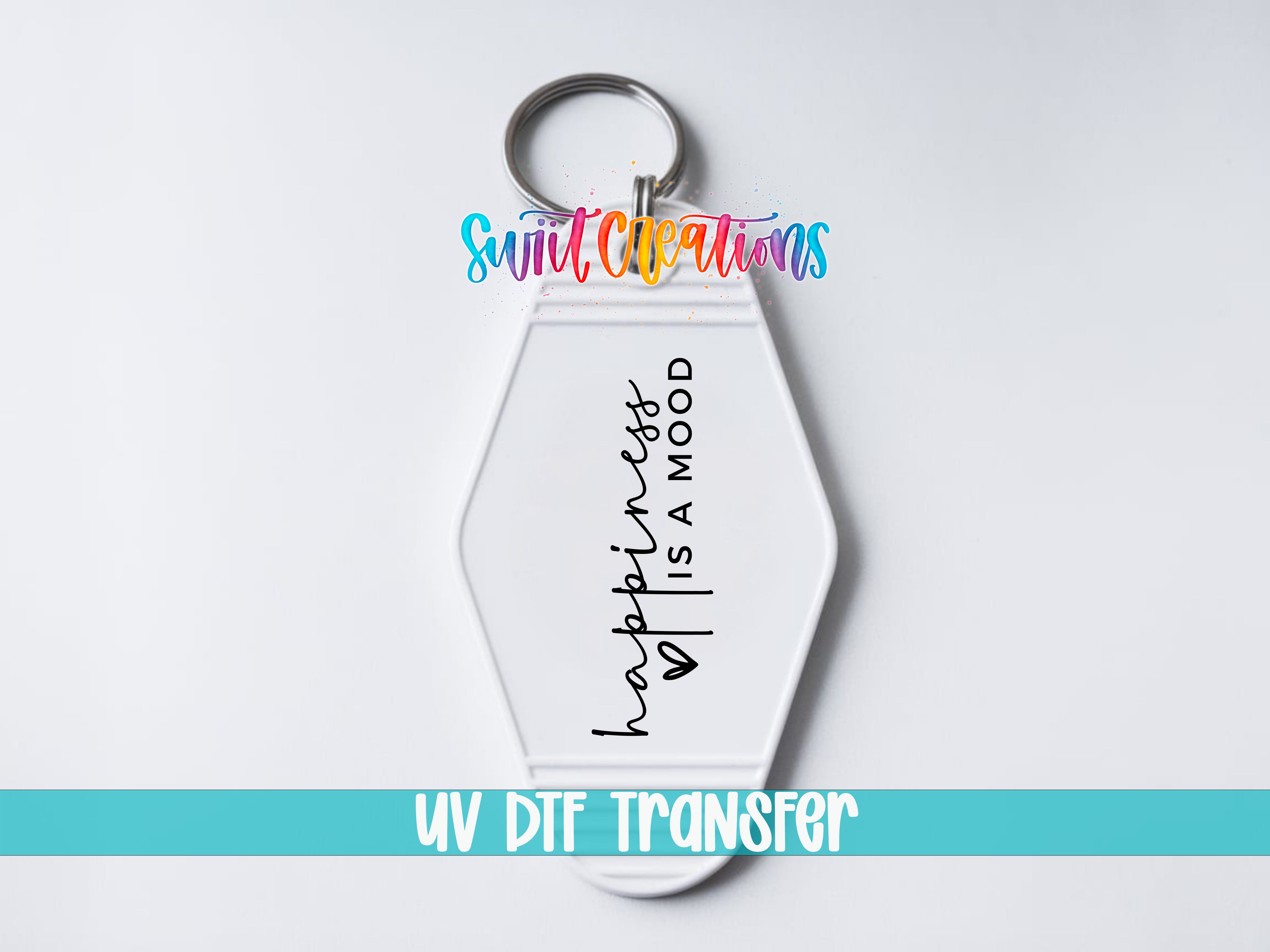 A keychain with the text "happiness is a mood" printed on it, along with a UV dye transfer logo.