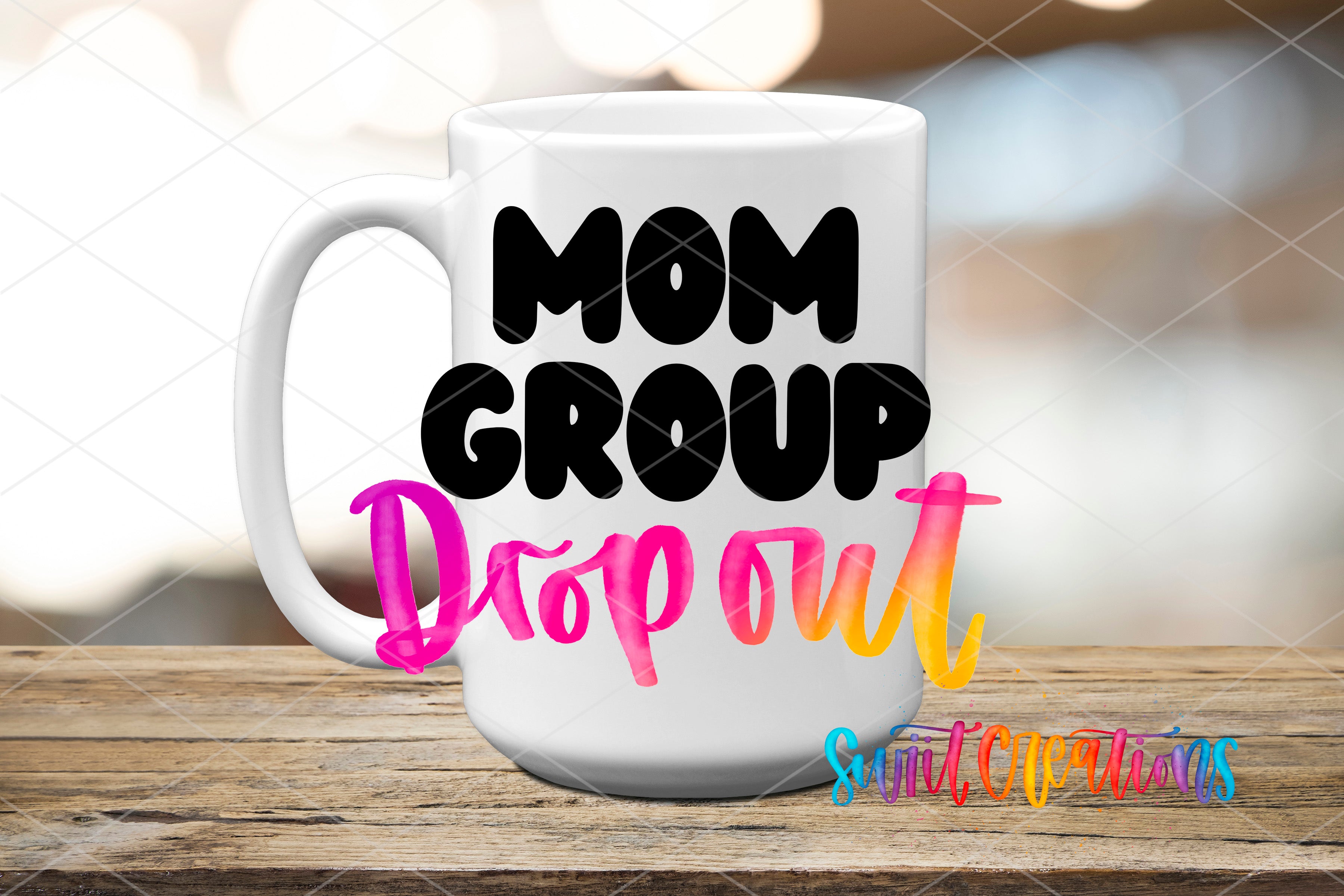A white mug with the text "MOM GROUP DROP OUT" printed on it, placed on a wooden surface.