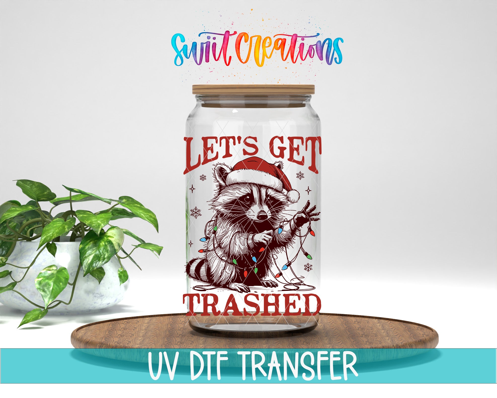 A jar with a raccoon wearing a Santa hat and the text "Let's get trampled" printed on it, placed on a wooden surface.
