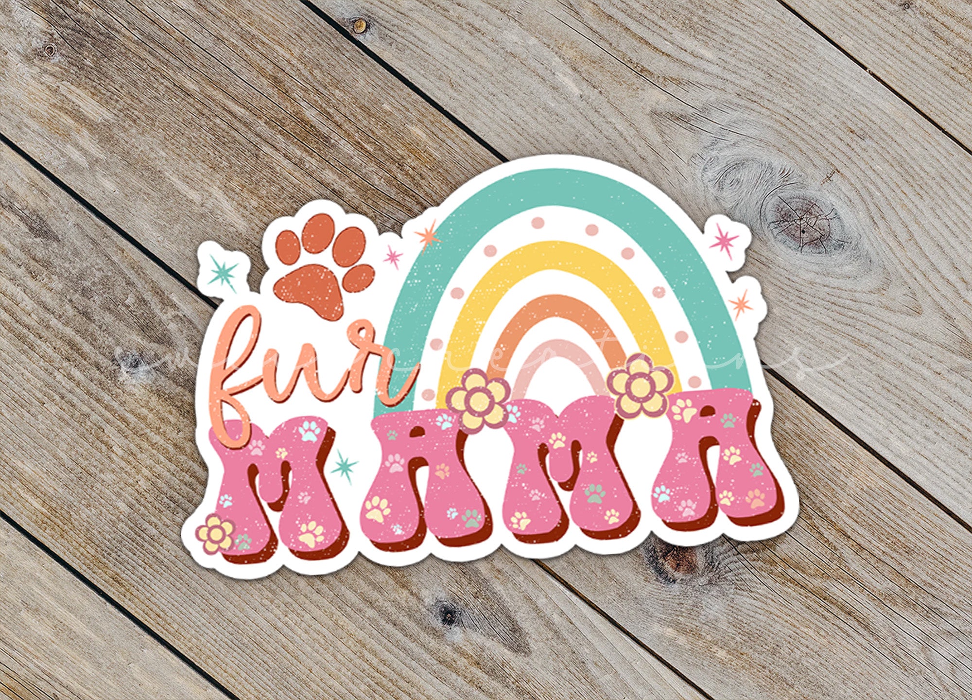 a sticker with a rainbow and paw prints on it