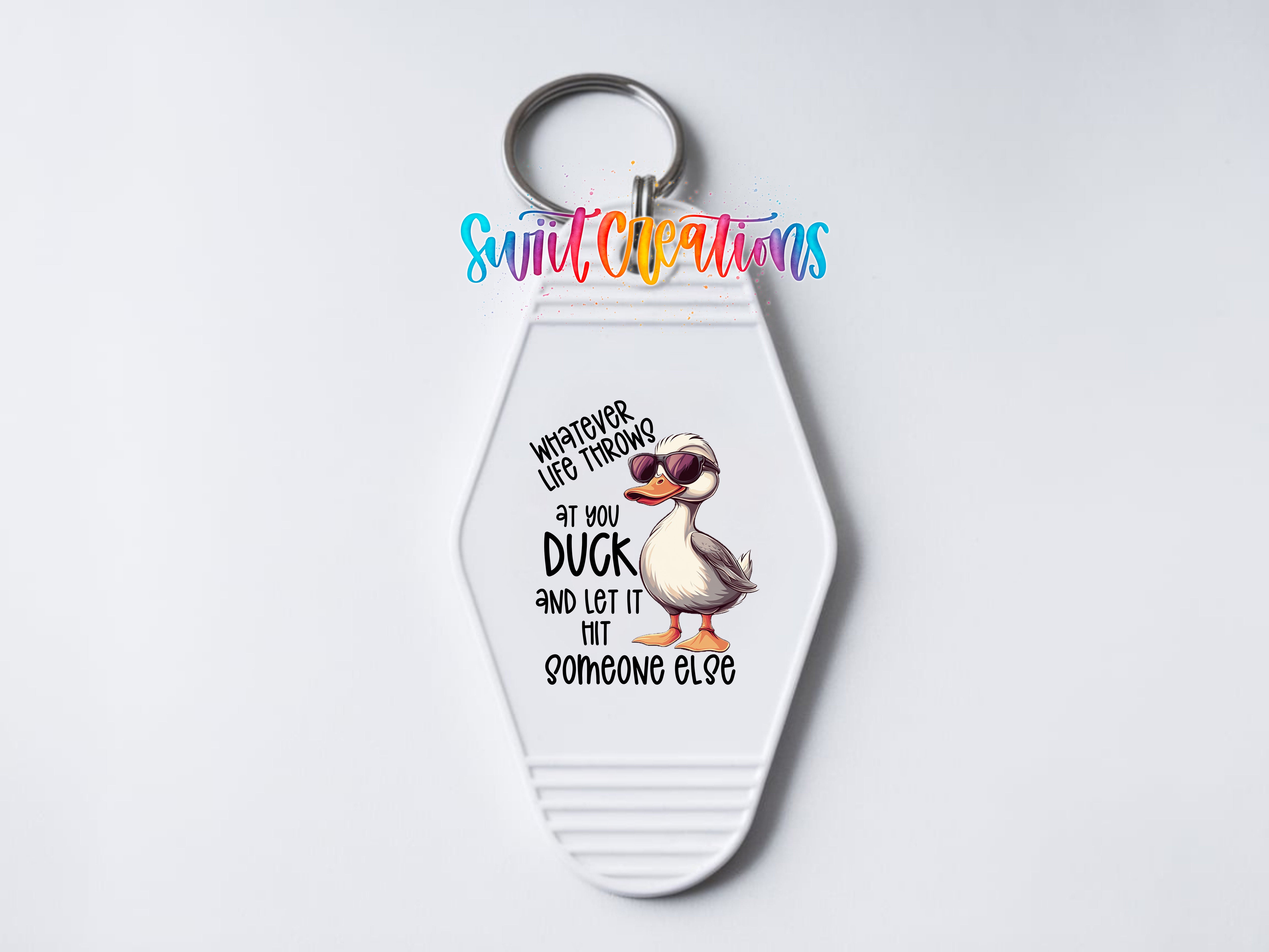 A keychain with a cartoon duck wearing sunglasses and the text "Whatever life throws at you, let it hit someone else" printed on it.