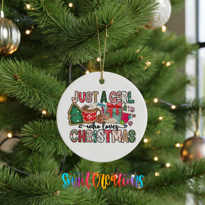 A Christmas tree decorated with ornaments, including a white ornament with text that says "Just a girl who loves Christmas".