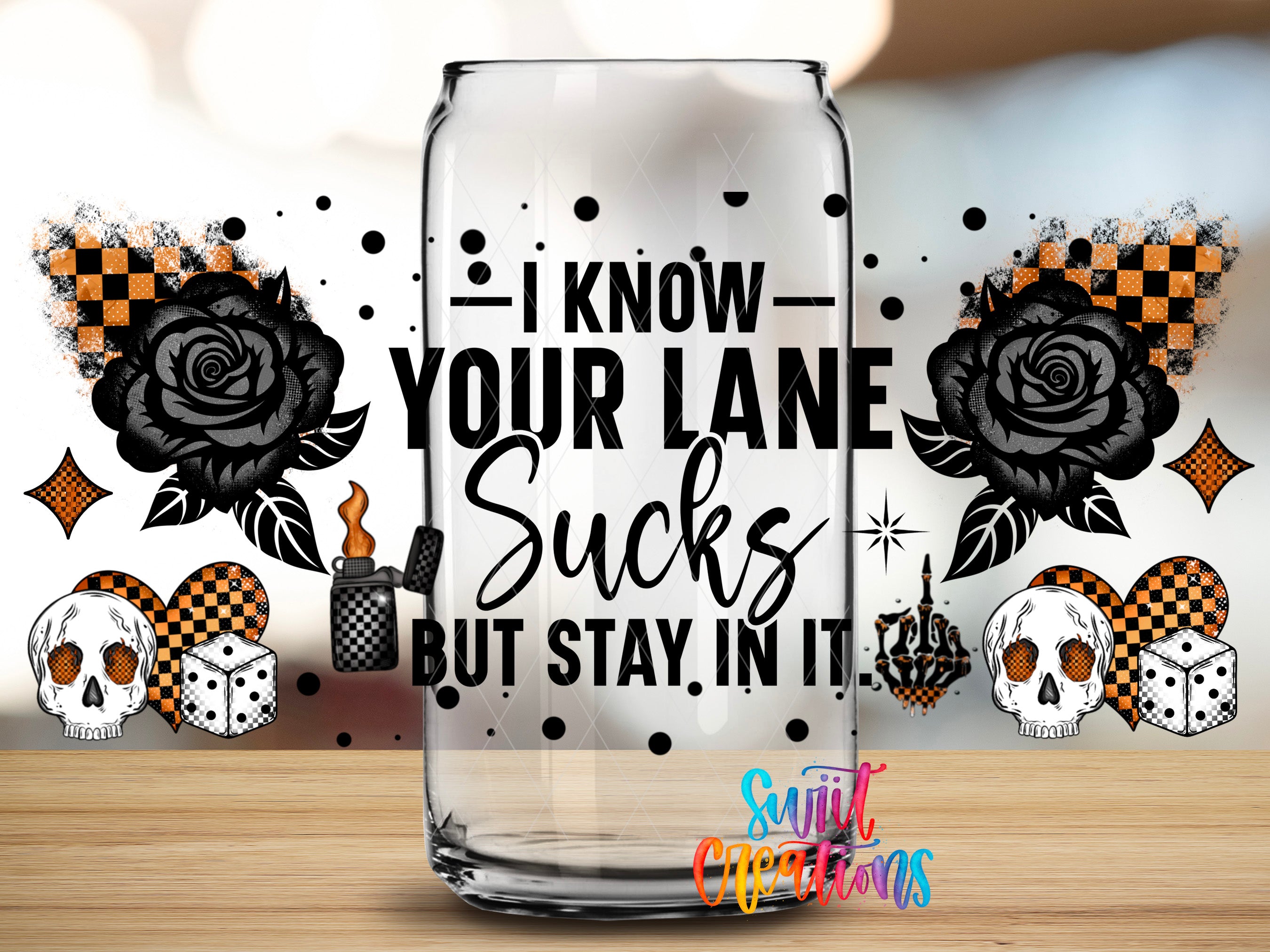 a glass can with a humorous text that reads "I know your lane sucks but stay in it." The can is surrounded by various graphic elements, including skulls, roses, and dice, creating a visually striking and edgy design.