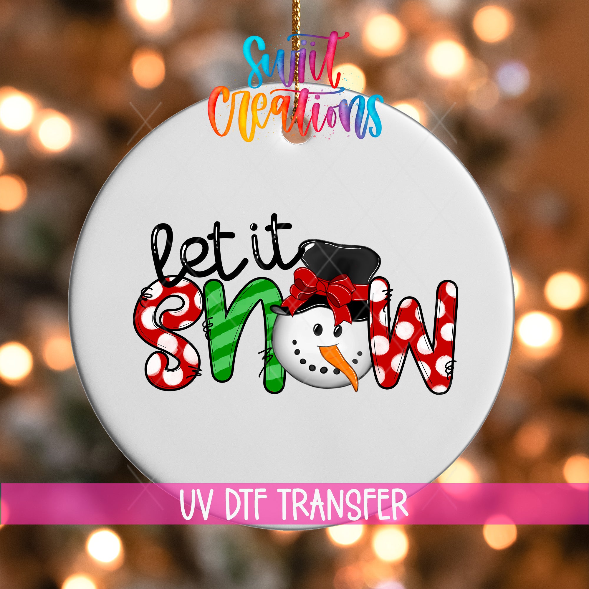A white ornament with the text "let it snow" and a snowman graphic, hanging against a background of colorful lights.